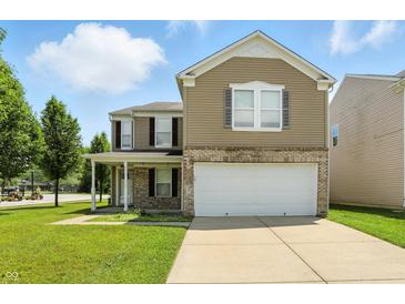 Charming two-story home with a well-maintained lawn and a two-car garage at 8301 Wheatfield Dr, Camby, IN 46113