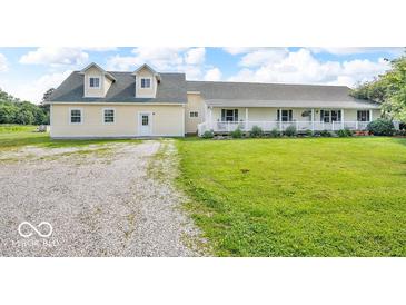 Charming exterior view of the home showcasing the well-maintained lawn and inviting architecture at 10705 N State Road 267, Brownsburg, IN 46112