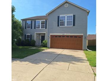 Charming two-story home featuring a two-car garage, tidy landscaping, and classic curb appeal at 10775 Cyrus Dr, Indianapolis, IN 46231