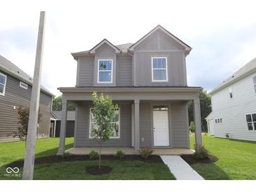 Charming two-story home with a covered front porch and well-manicured lawn showcasing curb appeal at 1817 Real St, Indianapolis, IN 46240