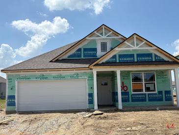 Charming single-story home with a two-car garage under construction with blue sky and clouds at 188 Springfield Xing, Greenfield, IN 46140