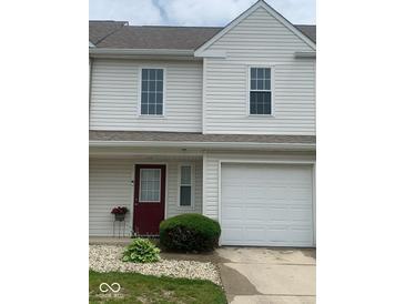Charming townhome with a well-maintained lawn, an attached one car garage, and a red door at 459 Dekalb Dr, Westfield, IN 46074