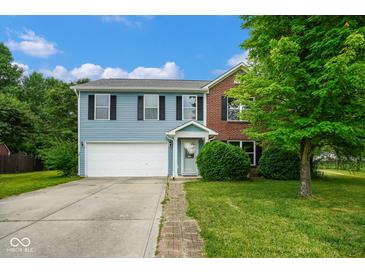 Charming two-story home with blue siding, brick accents, and attached two-car garage at 8047 Red Barn Cir, Indianapolis, IN 46239