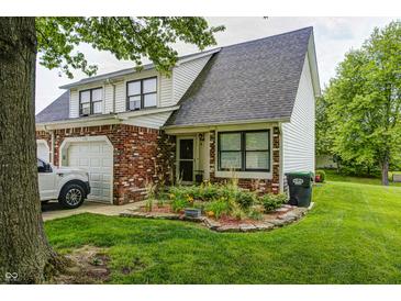 Charming two-story townhouse with brick and siding, a well-manicured lawn, and a one-car garage at 1106 Barbara Dr, Greenwood, IN 46143