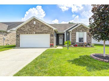 Charming single-story home with a brick facade, well-manicured lawn, and attached two car garage at 1187 Blackthorne S Trl, Plainfield, IN 46168