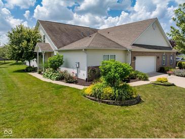 Charming home featuring well-maintained landscaping, lawn, brick accents, and a two-car garage at 1201 Fantail Dr, Greenwood, IN 46143