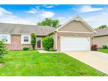 Charming home featuring a two-car garage, brick accents, and a well-maintained lawn at 1331 Mccormicks Cir, Danville, IN 46122