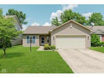 Charming single-story home featuring a two-car garage, well-manicured lawn, and blue shutters at 15388 Dry Creek Rd, Noblesville, IN 46060