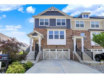 Beautiful two-story brick townhouse with a two-car garage and well-maintained landscaping at 16057 Coleman Dr, Westfield, IN 46074