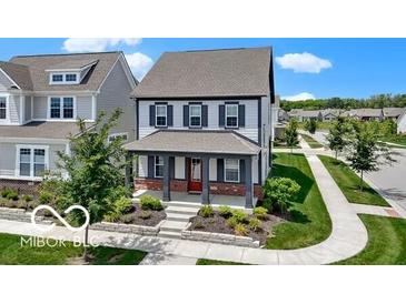 Charming two-story home with front porch, landscaping, and traditional architectural details at 1892 Ponsonby Dr, Westfield, IN 46074