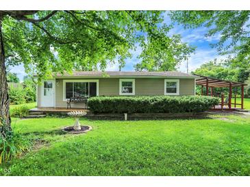 Charming single-story home featuring a welcoming front porch and a well-maintained, lush green lawn at 217 W Burnside Ave, Fairland, IN 46126
