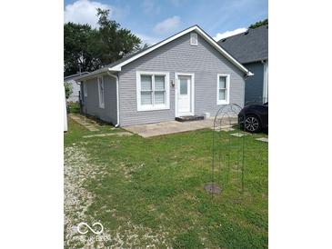 Charming single-story home with gray siding, well-maintained lawn, and inviting entrance at 3330 S Mooresville Rd, Indianapolis, IN 46221