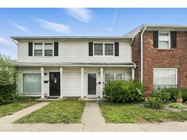 Traditional two-story townhome featuring a classic white facade, black shutters and neatly kept lawn at 3343 Ashley Ln, Indianapolis, IN 46224