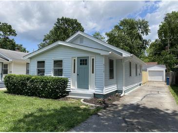 Charming home featuring light blue siding, tidy front yard, and a convenient private driveway at 5115 Primrose Ave, Indianapolis, IN 46205