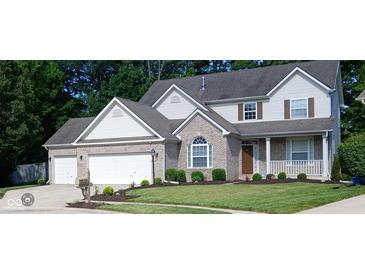 Charming two-story home with a brick facade, white siding, attached garage, and well-manicured lawn at 6483 Timber Walk Dr, Indianapolis, IN 46236