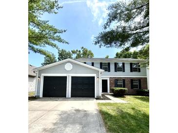 Charming two-story home featuring a two-car garage and a well-maintained lawn at 6839 Antelope Dr, Indianapolis, IN 46278