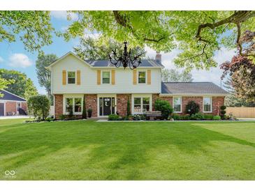 Charming two-story home featuring a well-manicured lawn and classic architectural details at 8201 Castle Dr, Indianapolis, IN 46256