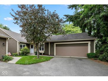 Charming home featuring a two-car garage and mature tree in a quiet neighborhood setting at 4609 Framington Ct, Indianapolis, IN 46254