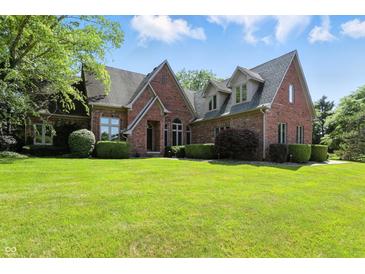 Stunning brick home with lush green lawn and manicured landscaping, creating a welcoming curb appeal at 6183 Whitetail Run, Greenwood, IN 46143