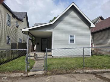 Charming bungalow featuring a gray exterior, covered porch and chain link fence at 624 Warren Ave, Indianapolis, IN 46221
