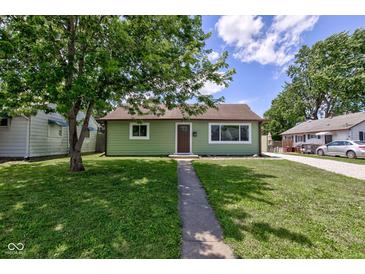 Charming single-story home with green exterior, well-maintained lawn, and inviting walkway at 710 S Bancroft St, Indianapolis, IN 46203