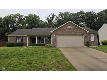Charming brick ranch home with a two-car garage and well-maintained lawn at 7440 Oakview Dr, Avon, IN 46123