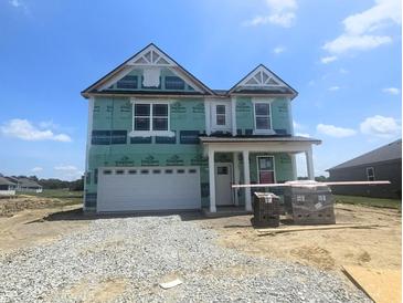 Two-story home with attached garage and green protective wrap at 114 Velvet Hat Rd, Danville, IN 46122