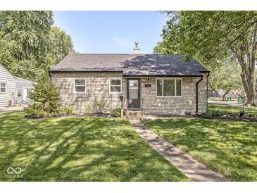 Charming stone home with a well-maintained lawn and walkway leading to the front door at 1205 Park Dr, Lebanon, IN 46052