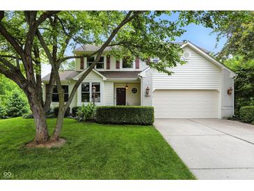 Charming two-story home with a well-manicured lawn and attached two-car garage, creating a welcoming curb appeal at 13020 Lombard Ct, Fishers, IN 46038