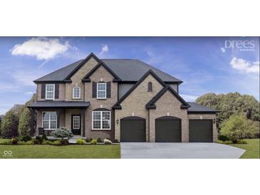 Beautiful two-story brick and stone home with a three-car garage and black shutters at 1452 E Greyhound E Pass, Carmel, IN 46032
