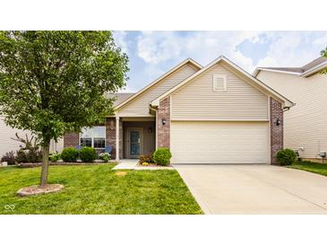 Charming single-Gathering home featuring manicured lawn, brick accents, and an attached two-car garage at 17183 Petersfield Ln, Westfield, IN 46074