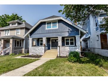 Charming two-story home with blue siding, white brick accents, and a well-manicured lawn at 2954 N Washington Blvd, Indianapolis, IN 46205