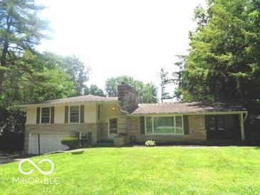 Charming home with a brick chimney and well-maintained lawn at 3253 W 34Th St, Indianapolis, IN 46222