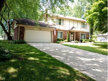 Charming two-story home with a well-maintained lawn, a two-car garage, and classic brick accents at 336 N Windsong Ln, Greenwood, IN 46142