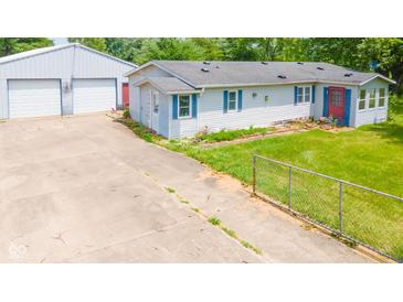 Charming single-story home with a large detached garage and a spacious concrete driveway at 4644 E 150 N, Anderson, IN 46012