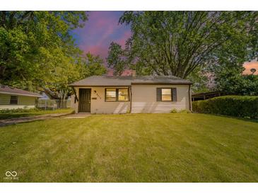 Charming single-story home with a well-maintained lawn and mature trees at 8210 Patton Dr, Lawrence, IN 46226