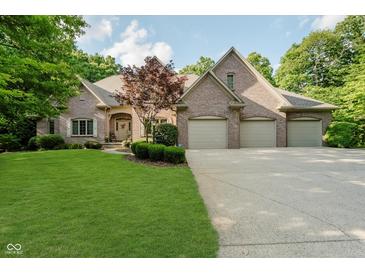 Attractive brick home featuring an attached three car garage and meticulously maintained lawn at 9190 Hastings Trce, Indianapolis, IN 46234