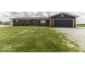 Charming brick home with a well-manicured lawn and an attached garage, perfect for comfortable living at 10769 Shelbyville Rd, Indianapolis, IN 46259
