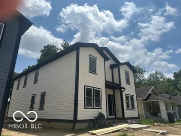 Two-story home featuring black trim, white siding, and double hung windows at 2879-81 N Dearborn St, Indianapolis, IN 46218