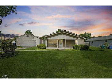 Charming single-story home featuring a well-maintained lawn and a detached garage at 3304 Coffey St, Indianapolis, IN 46217