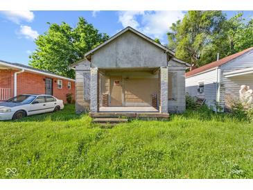 This property needs work, including overgrown grass and boarded-up windows at 3335 W 9Th St, Indianapolis, IN 46222