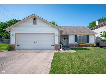 Charming one-story home with attached garage, well-manicured lawn and welcoming front porch at 1112 Berwyn Rd, Whiteland, IN 46184