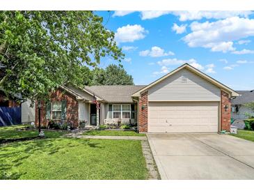 Charming home with brick accents, landscaped front yard, and a well-maintained lawn at 17401 Austrian Pine Way, Westfield, IN 46074