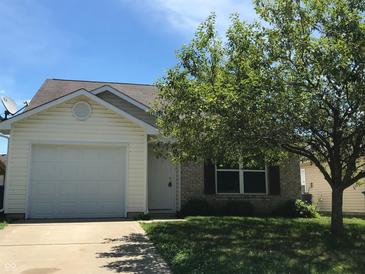 Charming single-Gathering home with well-maintained lawn, attached garage, and mature shade tree at 3929 Roundwood Dr, Indianapolis, IN 46235