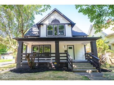 Charming two-story home with a welcoming front porch and landscaped yard at 402 N Oxford St, Indianapolis, IN 46201