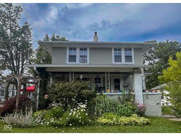 Charming two-story home with covered porch and lush front garden at 430 W Locust St, Shelbyville, IN 46176