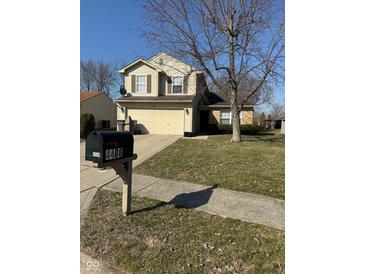 Charming two-story home with a well-maintained front yard and attached two-car garage at 4408 Vestry Pl, Indianapolis, IN 46237