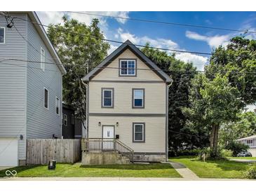 Charming two-story home featuring updated siding, front porch and manicured front lawn at 629 E 25Th St, Indianapolis, IN 46205