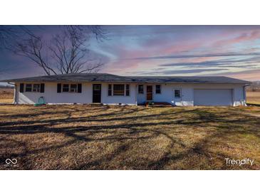 Inviting exterior showcasing a one-story home with a well-maintained lawn and attached garage at 7300 N Banta Rd, Bargersville, IN 46106