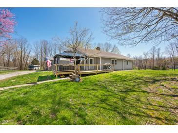 Charming single story home with an inviting deck and pergola overlooking the lush green lawn at 9267 N State Road 135, Morgantown, IN 46160